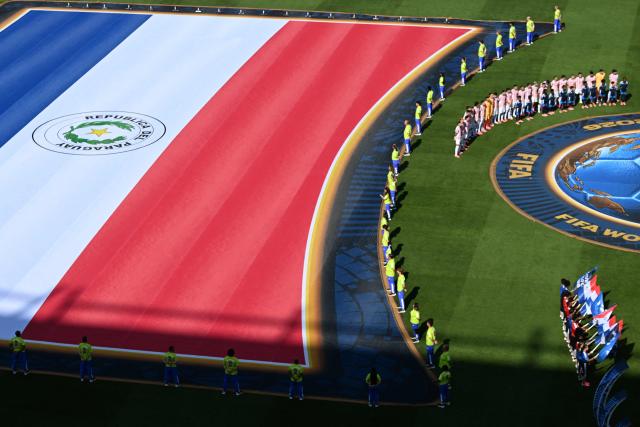 Paraguay's players stand for their national anthem ahead of the 2026 World Cup round of 16 football match between Paraguay and France at the Philadelphia Stadium in Philadelphia on July 4, 2026.  (Photo by Jewel SAMAD / AFP)