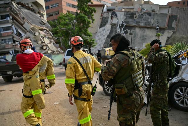 Brazilian rescuers arrive with members of the Venezuelan security forces in Catia La Mar, La Guaira state, Venezuela on July 4, 2026, following the June 24 twin earthquakes. The death toll from Venezuela's devastating twin earthquakes has risen to 2,954, according to official figures released on Saturday. (Photo by MARTIN BERNETTI / AFP)