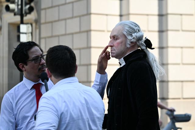 A man is dressed as George Washington, the first President of the United States, during the "Salute to America" Independence Day celebration on the National Mall in Washington, DC, on July 4, 2026. The nation is marking the 250th anniversary of the United States Declaration of Indpendence. (Photo by Alex WROBLEWSKI / AFP)