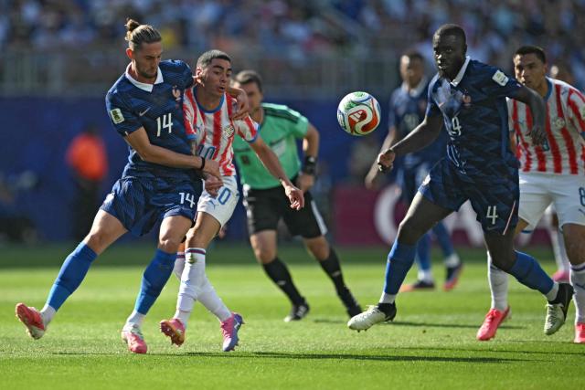 (L-R) France's midfielder #14 Adrien Rabiot and Paraguay's midfielder #10 Miguel Almiron fight for the ball past France's defender #04 Dayot Upamecano and Paraguay's midfielder #08 Diego Gomez during the 2026 World Cup round of 16 football match between Paraguay and France at the Philadelphia Stadium in Philadelphia on July 4, 2026.  (Photo by MAURO PIMENTEL / AFP)