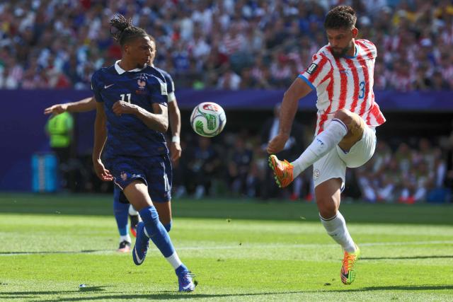 Paraguay's defender #03 Omar Alderete (R) kicks the ball past France's forward #11 Michael Olise during the 2026 World Cup round of 16 football match between Paraguay and France at the Philadelphia Stadium in Philadelphia on July 4, 2026.  (Photo by Odd ANDERSEN / AFP)