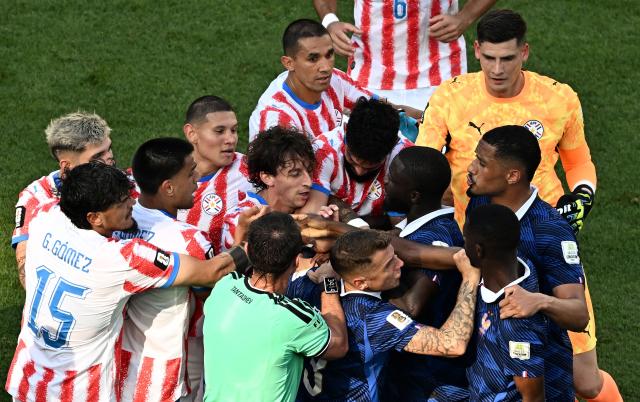 Paraguay and France players argue apst Uzbek referee Ilgiz Tantashev during the 2026 World Cup round of 16 football match between Paraguay and France at the Philadelphia Stadium in Philadelphia on July 4, 2026.  (Photo by Jewel SAMAD / AFP)