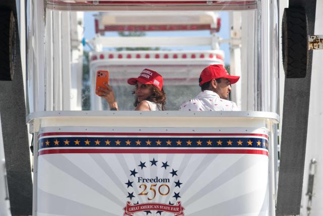 People ride the Ferris wheel at the Great American State Fair during the "Salute to America" Independence Day celebration on the National Mall in Washington, DC, on July 4, 2026. The nation is marking the 250th anniversary of the United States Declaration of Indpendence. (Photo by Matthew HATCHER / AFP)