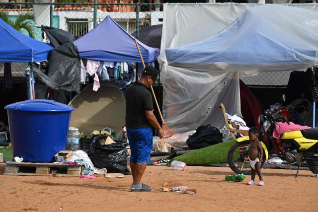 Survivors remain at a makeshift camp in La Guaira, Venezuela on July 4, 2026, following the June 24 twin earthquakes. With little hope of finding loved ones alive, frustrated families of those affected by Venezuela's double earthquakes clamor for help to recover their loved one's bodies as uncertainty grows over the death toll from the tragedy. (Photo by Raul ARBOLEDA / AFP)