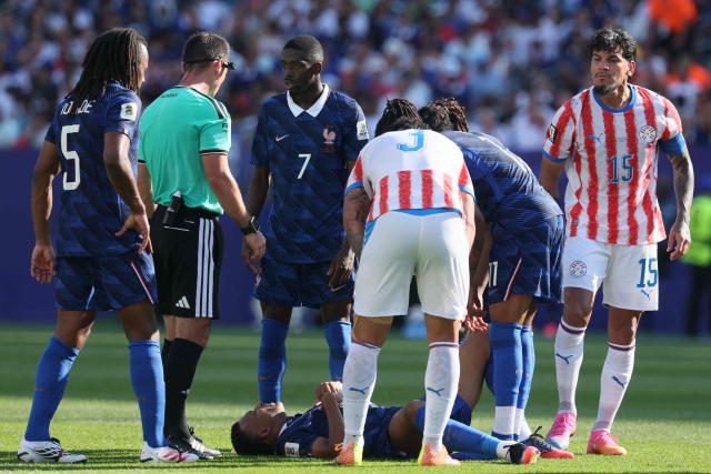France's forward #10 Kylian Mbappe lies on the ground next to teammate France's forward #07 Ousmane Dembele and Paraguay's defender #15 Gustavo Gomez during the 2026 World Cup round of 16 football match between Paraguay and France at the Philadelphia Stadium in Philadelphia on July 4, 2026.  (Photo by Odd ANDERSEN / AFP)