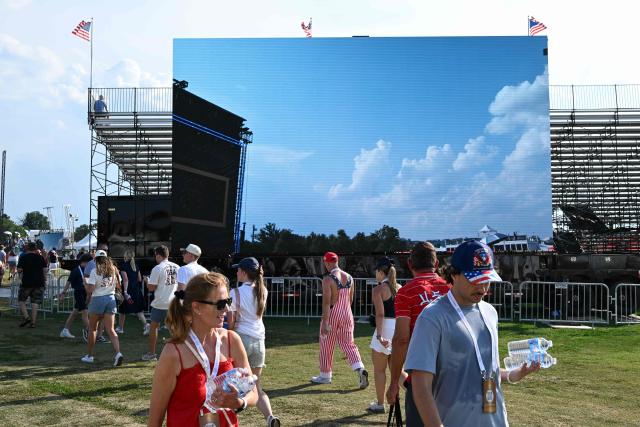 People carry bottles of water as they attend the "Salute to America" Independence Day celebration on the National Mall in Washington, DC, on July 4, 2026. The nation is marking the 250th anniversary of the United States Declaration of Indpendence. (Photo by Alex WROBLEWSKI / AFP)