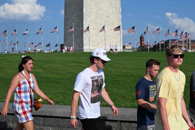 People walk near the base of the Washington Monument as they attend the "Salute to America" Independence Day celebration on the National Mall in Washington, DC, on July 4, 2026. The nation is marking the 250th anniversary of the United States Declaration of Indpendence. (Photo by Alex WROBLEWSKI / AFP)