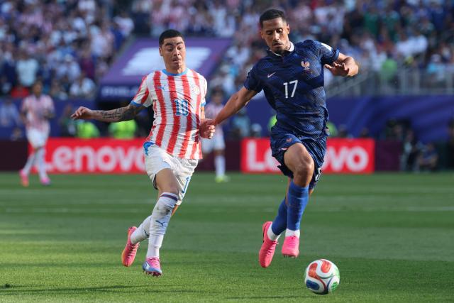 Paraguay's midfielder #10 Miguel Almiron and France's defender #17 William Saliba fight for the ball during the 2026 World Cup round of 16 football match between Paraguay and France at the Philadelphia Stadium in Philadelphia on July 4, 2026.  (Photo by Odd ANDERSEN / AFP)