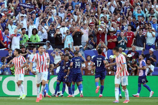 France's forward #10 Kylian Mbappe celebrates scoring his team's first goal with teammates during the 2026 World Cup round of 16 football match between Paraguay and France at the Philadelphia Stadium in Philadelphia on July 4, 2026.  (Photo by Odd ANDERSEN / AFP)