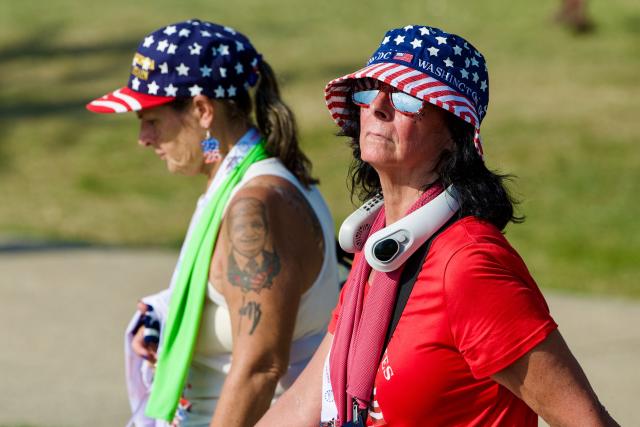 People wear patriotic hats as they attend the "Salute to America" Independence Day celebration on the National Mall in Washington, DC, on July 4, 2026. The nation is marking the 250th anniversary of the United States Declaration of Indpendence. (Photo by Amid FARAHI / AFP)