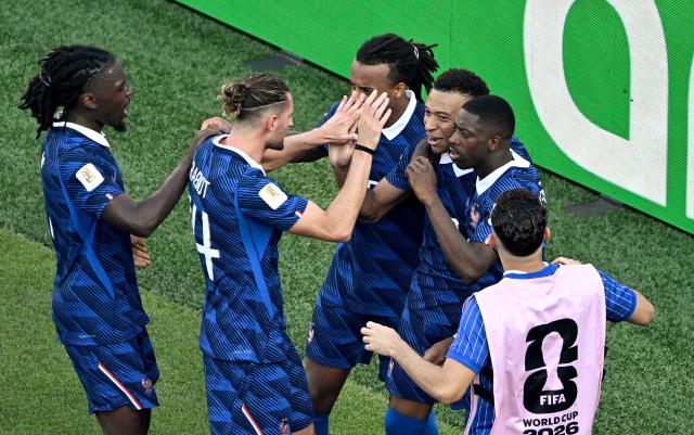 France's forward #10 Kylian Mbappe celebrates with teammates after scoring his team's first goal from the penalty spot during the 2026 World Cup round of 16 football match between Paraguay and France at the Philadelphia Stadium in Philadelphia on July 4, 2026.  (Photo by Jewel SAMAD / AFP)