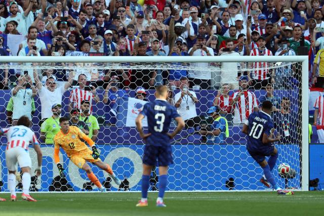 France's forward #10 Kylian Mbappe scores his team's first goal from the penalty spot past Paraguay's goalkeeper #12 Orlando Gill during the 2026 World Cup round of 16 football match between Paraguay and France at the Philadelphia Stadium in Philadelphia on July 4, 2026.  (Photo by Odd ANDERSEN / AFP)