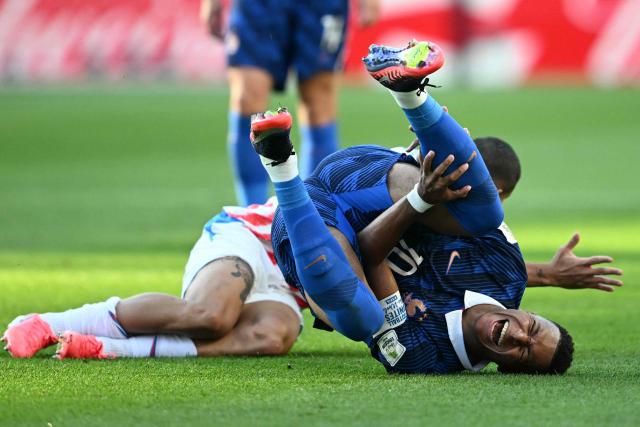 France's forward #10 Kylian Mbappe reacts on the ground past Paraguay's defender #04 Juan Jose Caceres during the 2026 World Cup round of 16 football match between Paraguay and France at the Philadelphia Stadium in Philadelphia on July 4, 2026.  (Photo by MAURO PIMENTEL / AFP)