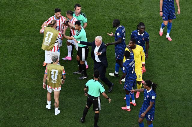 France's head coach Didier Deschamps separates Paraguay and France players during the 2026 World Cup round of 16 football match between Paraguay and France at the Philadelphia Stadium in Philadelphia on July 4, 2026.  (Photo by Jewel SAMAD / AFP)