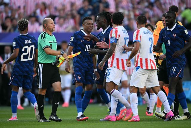 France's forward #10 Kylian Mbappe argues with Paraguay's defender #02 Gustavo Velazquez and defender #15 Gustavo Gomez during the 2026 World Cup round of 16 football match between Paraguay and France at the Philadelphia Stadium in Philadelphia on July 4, 2026.  (Photo by MAURO PIMENTEL / AFP)