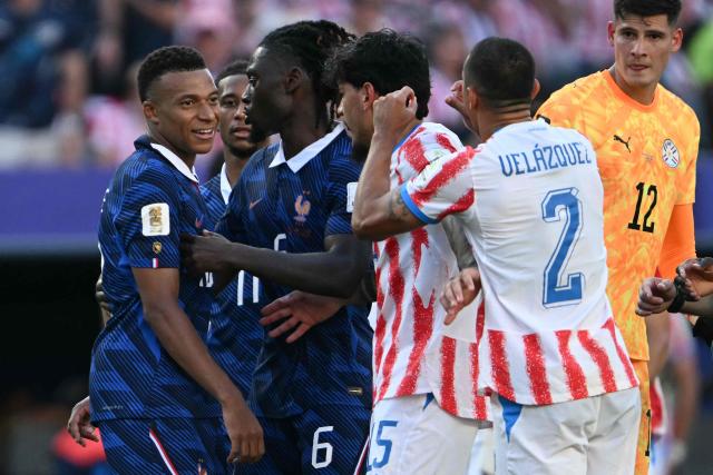 France's forward #10 Kylian Mbappe argues with Paraguay's defender #02 Gustavo Velazquez and defender #15 Gustavo Gomez during the 2026 World Cup round of 16 football match between Paraguay and France at the Philadelphia Stadium in Philadelphia on July 4, 2026.  (Photo by MAURO PIMENTEL / AFP)