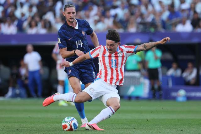Paraguay's midfielder #11 Mauricio kicks the ball past France's midfielder #14 Adrien Rabiot during the 2026 World Cup round of 16 football match between Paraguay and France at the Philadelphia Stadium in Philadelphia on July 4, 2026.  (Photo by Odd ANDERSEN / AFP)