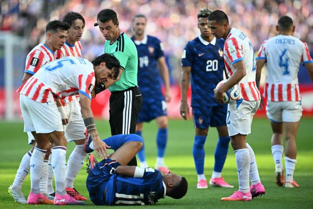 France's forward #10 Kylian Mbappe reacts on the ground past Paraguay's defender #15 Gustavo Gomez during the 2026 World Cup round of 16 football match between Paraguay and France at the Philadelphia Stadium in Philadelphia on July 4, 2026.  (Photo by MAURO PIMENTEL / AFP)