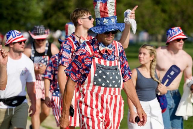 People wearing Americana-themed outfits attend the “Salute to America” Independence Day celebration on the National Mall in Washington, DC, on July 4, 2026. The nation is marking the 250th anniversary of the United States Declaration of Indpendence. (Photo by Amid FARAHI / AFP)