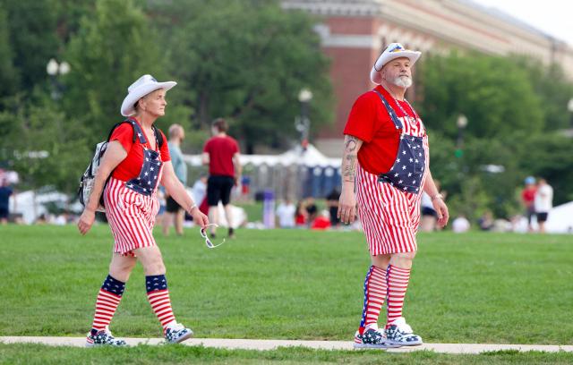 People wearing Americana-themed outfits attend the “Salute to America” Independence Day celebration on the National Mall in Washington, DC, on July 4, 2026. The nation is marking the 250th anniversary of the United States Declaration of Indpendence. (Photo by Amid FARAHI / AFP)