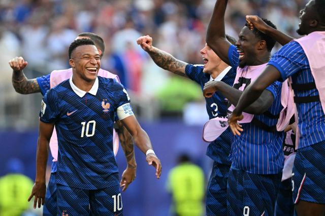 France's forward #10 Kylian Mbappe celebrates with teammates after winning the 2026 World Cup round of 16 football match between Paraguay and France at the Philadelphia Stadium in Philadelphia on July 4, 2026.  (Photo by MAURO PIMENTEL / AFP)