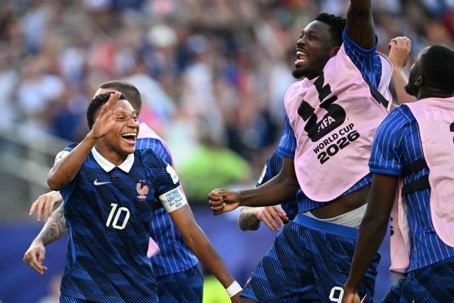 France's forward #10 Kylian Mbappe celebrates with teammates after winning the 2026 World Cup round of 16 football match between Paraguay and France at the Philadelphia Stadium in Philadelphia on July 4, 2026.  (Photo by MAURO PIMENTEL / AFP)