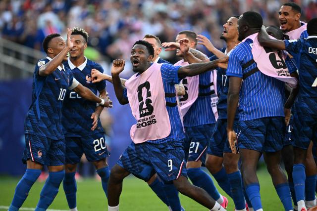 France's forward #09 Marcus Thuram celebrates with teammates after winning the 2026 World Cup round of 16 football match between Paraguay and France at the Philadelphia Stadium in Philadelphia on July 4, 2026.  (Photo by MAURO PIMENTEL / AFP)