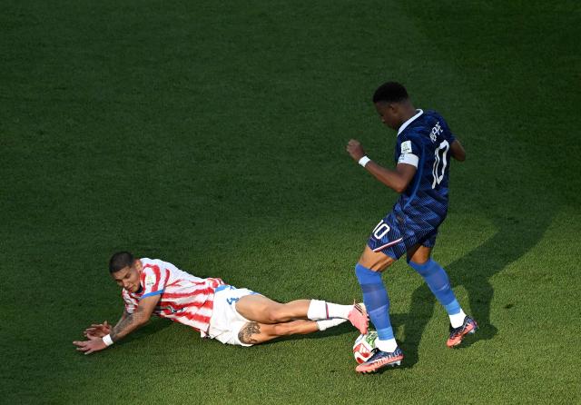 France's forward #10 Kylian Mbappe and Paraguay's defender #04 Juan Jose Caceres fight for the ball during the 2026 World Cup round of 16 football match between Paraguay and France at the Philadelphia Stadium in Philadelphia on July 4, 2026.  (Photo by Jewel SAMAD / AFP)