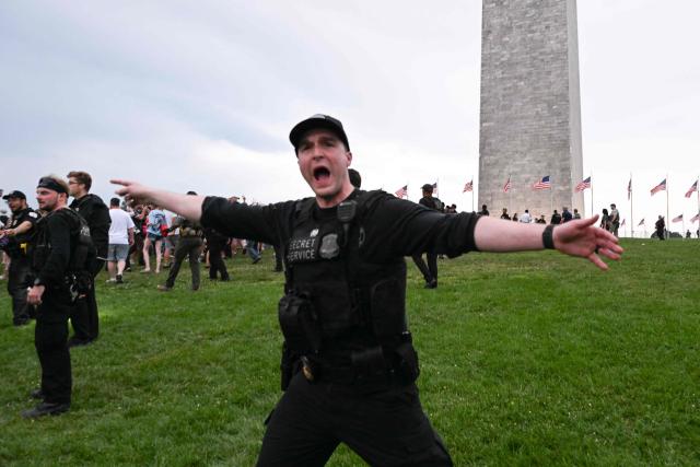 Members of the US Secret Service direct people to evacuation the National Mall due to thunderstorms in the area during the "Salute to America" Independence Day celebration in Washington, DC, on July 4, 2026. The nation is marking the 250th anniversary of the United States Declaration of Indpendence. (Photo by Alex WROBLEWSKI / AFP)