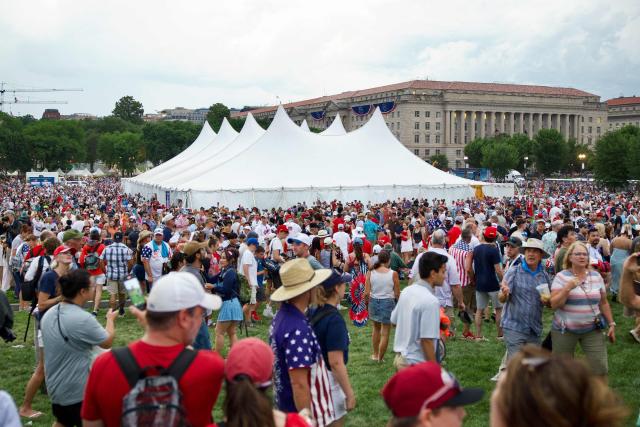 People gather near the Washington Monument after being evacuated from the event site of the "Salute to America" Independence Day celebration due to thunderstorms in the area in Washington, DC, on July 4, 2026. The nation is marking the 250th anniversary of the United States Declaration of Indpendence. (Photo by Amid FARAHI / AFP)