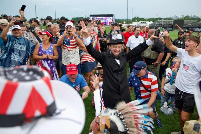 People gather near the Washington Monument after being evacuated from the event site of the "Salute to America" Independence Day celebration due to thunderstorms in the area in Washington, DC, on July 4, 2026. The nation is marking the 250th anniversary of the United States Declaration of Indpendence. (Photo by Amid FARAHI / AFP)