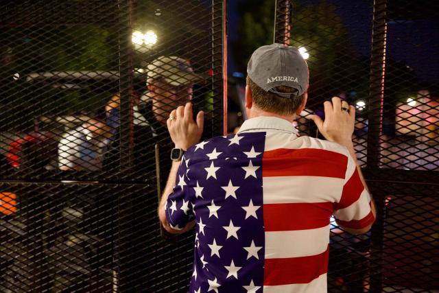 People wait to re-enter the event site after being evacuated due to storms in the area during the "Salute to America" Independence Day celebration on the National Mall in Washington, DC, on July 4, 2026. The nation is marking the 250th anniversary of the United States Declaration of Indpendence. (Photo by Amid FARAHI / AFP)