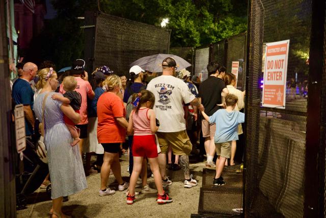 People wait to re-enter the event site after being evacuated due to storms in the area during the "Salute to America" Independence Day celebration on the National Mall in Washington, DC, on July 4, 2026. The nation is marking the 250th anniversary of the United States Declaration of Indpendence. (Photo by Amid FARAHI / AFP)