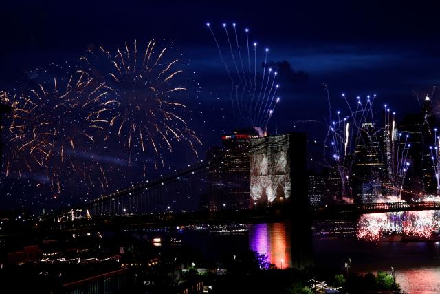 Fireworks light up the illuminated Brooklyn Bridge during the Macy's Fourth of July Fireworks celebration in New York City, on July 4, 2026. (Photo by Leonardo MUNOZ / AFP)