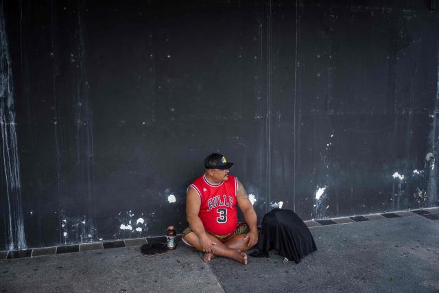 A homeless man waits for a bus to shelter as the forecasted Super Typhoon Bavi approaches in Guam, Northern Mariana Islands, on July 5, 2026. (Photo by Yuichi YAMAZAKI / AFP)