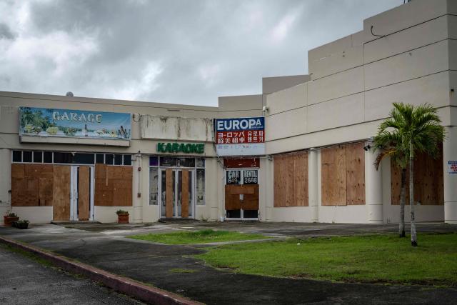 Stores boarded up with plywood are seen as the forecasted Super Typhoon Bavi approaches in Guam, Northern Mariana Islands, on July 5, 2026. (Photo by Yuichi YAMAZAKI / AFP)