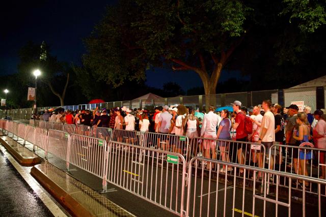 People line up to re-enter the event site after being evacuated due to storms in the area during the "Salute to America" Independence Day celebration on the National Mall in Washington, DC, on July 4, 2026. The nation is marking the 250th anniversary of the United States Declaration of Indpendence. (Photo by Amid FARAHI / AFP)
