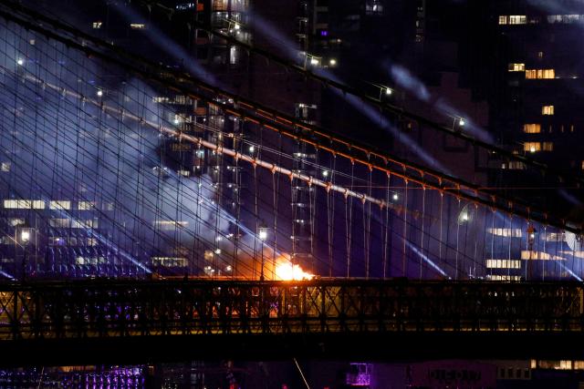 A fire burns on the Brooklyn Bridge after the Macy's Fourth of July Fireworks celebration in New York, on July 4, 2026. (Photo by Leonardo MUNOZ / AFP)