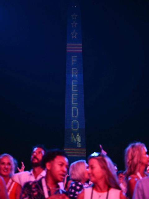 The Washington Monument is illuminated with the word "Freedom" as US President Donald Trump speaks during the "Salute to America" Independence Day celebration on the National Mall in Washington, DC, on July 4, 2026. The nation is marking the 250th anniversary of the United States Declaration of Indpendence. (Photo by Kent NISHIMURA / AFP)