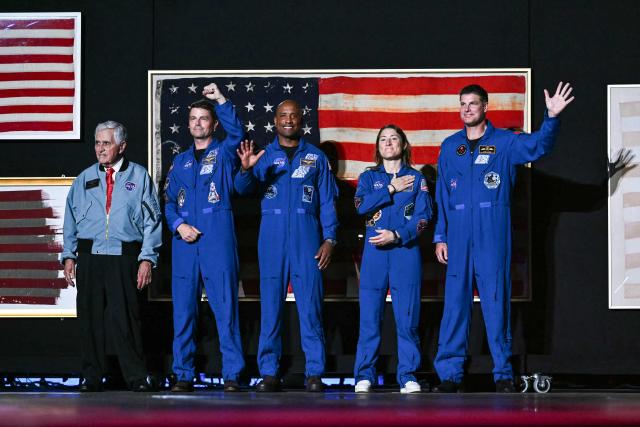 (L/R) Retired astronaut Harrison Schmitt, Artemis II crew members Reid Wiseman, Victor Glover, Christina Koch and Jeremy Hansen stand onstage as US President Donald Trump speaks during the "Salute to America" Independence Day celebration on the National Mall in Washington, DC, on July 4, 2026. The nation is marking the 250th anniversary of the United States Declaration of Indpendence. (Photo by Kent NISHIMURA / AFP)