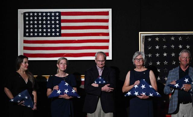 Gold Star family members stand on stage as US President Donald Trump (off frame) speaks during the “Salute to America” Independence Day celebration on the National Mall in Washington, DC, on July 4, 2026. The nation is marking the 250th anniversary of the United States Declaration of Indpendence. (Photo by Alex WROBLEWSKI / AFP)