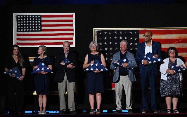 Gold Star family members stand on stage as US President Donald Trump (off frame) speaks during the “Salute to America” Independence Day celebration on the National Mall in Washington, DC, on July 4, 2026. The nation is marking the 250th anniversary of the United States Declaration of Indpendence. (Photo by Alex WROBLEWSKI / AFP)