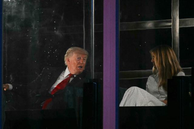 US President Donald Trump and First Lady Melania Trump watch the fireworks display during the "Salute to America" Independence Day celebration on the National Mall in Washington, DC, in the early morning hours of July 5, 2026. The nation is marking the 250th anniversary of the United States Declaration of Indpendence. (Photo by Kent NISHIMURA / AFP)