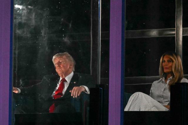 US President Donald Trump and First Lady Melania Trump watch the fireworks display during the "Salute to America" Independence Day celebration on the National Mall in Washington, DC, in the early morning hours of July 5, 2026. The nation is marking the 250th anniversary of the United States Declaration of Indpendence. (Photo by Kent NISHIMURA / AFP)