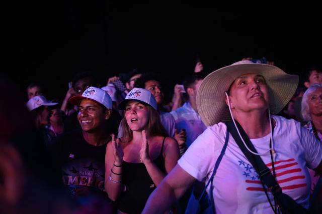 Attendees watch a fireworks display during the "Salute to America" Independence Day celebration on the National Mall in Washington, DC, in the early morning hours of July 5, 2026. The nation is marking the 250th anniversary of the United States Declaration of Indpendence. (Photo by Alex WROBLEWSKI / AFP)