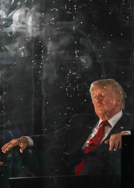 US President Donald Trump watches the fireworks display during the "Salute to America" Independence Day celebration on the National Mall in Washington, DC, in the early morning hours of July 5, 2026. The nation is marking the 250th anniversary of the United States Declaration of Indpendence. (Photo by Kent NISHIMURA / AFP)