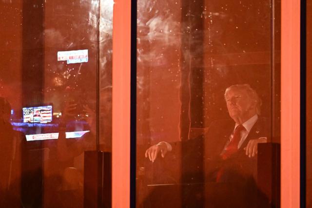 US President Donald Trump watches the fireworks display during the "Salute to America" Independence Day celebration on the National Mall in Washington, DC, in the early morning hours of July 5, 2026. The nation is marking the 250th anniversary of the United States Declaration of Indpendence. (Photo by Kent NISHIMURA / AFP)