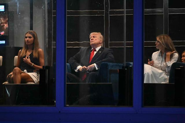 (L/R) Kai Trump, US President Donald Trump and First Lady Melania Trump watch the fireworks display during the "Salute to America" Independence Day celebration on the National Mall in Washington, DC, in the early morning hours of July 5, 2026. The nation is marking the 250th anniversary of the United States Declaration of Indpendence. (Photo by Kent NISHIMURA / AFP)