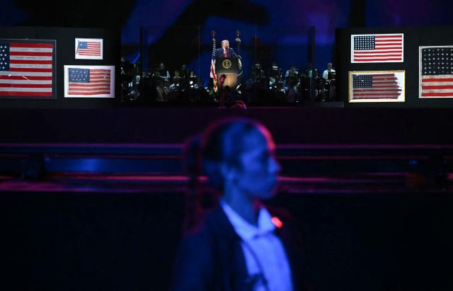 A member of the Secret Service stands in front of the stage as US President Donald Trump speaks during the "Salute to America" Independence Day celebration on the National Mall in Washington, DC, on July 4, 2026. The nation is marking the 250th anniversary of the United States Declaration of Indpendence. (Photo by Kent NISHIMURA / AFP)
