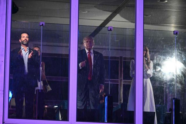 Donald Trump Jr. (L), US President Donald Trump (C) and US First Lady Melania Trump watch the fireworks display during the "Salute to America" Independence Day celebration on the National Mall in Washington, DC, in the early morning hours of July 5, 2026. The nation is marking the 250th anniversary of the United States Declaration of Indpendence. (Photo by Kent NISHIMURA / AFP)